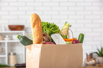 Shopping paper bag with fresh products in kitchen