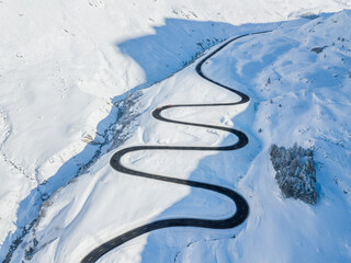 Aerial view of the winding road over the  Julier Pass in Swiss Alps mountain in winter full of snow, Canton Grison, Switzerland