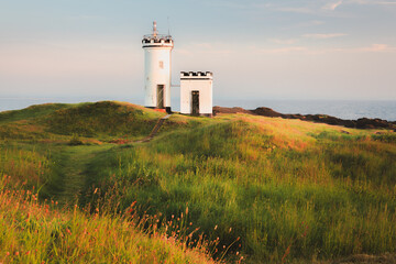 Scenic seascape landscape at sunset or sunrise of Elie Ness Lighthouse on the East Neuk Peninsula...