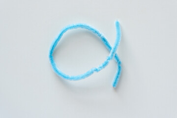 light blue flexible pipe cleaner folded upon itself