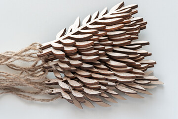 stack of decorative wooden leaf cutouts on paper