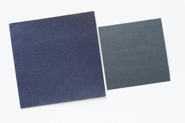 two paper squares on blank paper