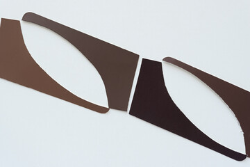 brown paper shapes with straight and curved sides on blank paper