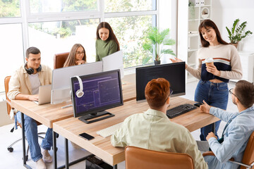 Team of young programmers working in office