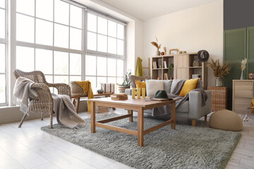 Interior of living room with grey sofa and table