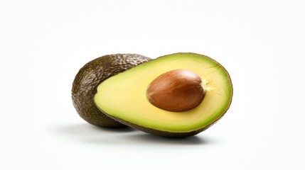 Avocado cut in half on a white surface. Suitable for food and nutrition-related content