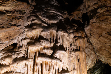 Amazing view of stalactites and stalagmites in colourful bright light, beautiful natural landmark...