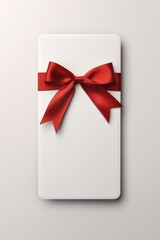 A white gift box with a vibrant red bow. Perfect for special occasions and gift-giving