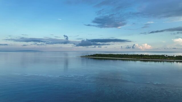 Early morning light illuminates the remote island of Koon near Seram, Indonesia. This scenic island's coral reefs, and the surrounding seas, support extraordinary marine biodiversity.
