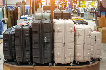 Row black white various sizes suitcases of simple colors on showcase display at an exhibition in a...