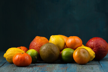 A variety of citrus fruits on a dark background