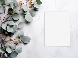 Top view mockup card on the white marble background with eucalyptus branches