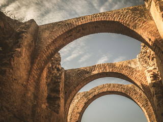 Arcos romanos de ladrillo en el Anfiteatro romano de Mérida, Extremadura, España. - obrazy, fototapety, plakaty