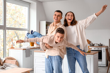 Little boy with his parents having fun at home