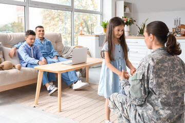 Little girl with her military mother at home