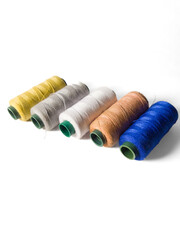 collection of sewing thread spools on a white background