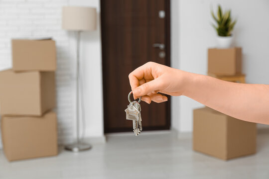 Woman with keys in her new flat, closeup