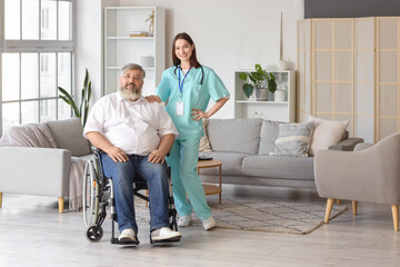 Mature man in wheelchair with nurse at home