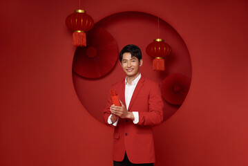 Happy Chinese new year. Asian man holding bamboo cylinder with fortune sticks or Esiimsi fortune...