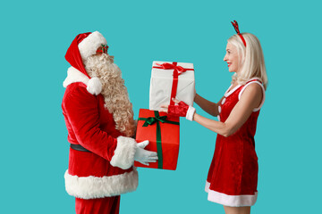 Santa and MRS Claus in Christmas deer horns with gift boxes on blue background