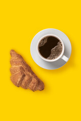 Top view image of сoffee and croissant breakfast on yellow background, minimalism art, flat lay, copy space