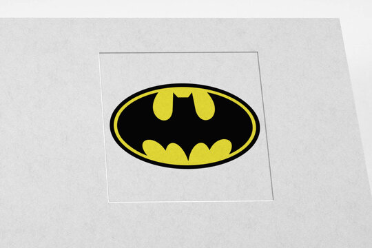 Batman logo printed on white paper.