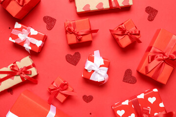 Many gift boxes and hearts on red background. Valentine's Day celebration