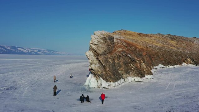 Aerial view of frozen Lake Baikal, Ogoy Island, Dragon Tooth rock cape. Siberia, Russia, 4k