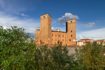 Fossano, Italy - Castle of the Princes of Acaja (14th century) in Castle Square over blue sky with...