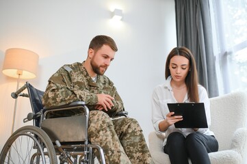 Young soldier in wheelchair at psychologist's office
