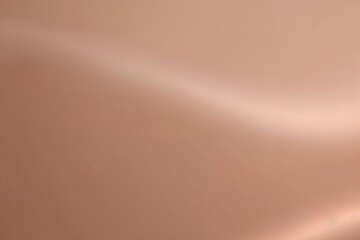 Abstract background in peach fuzz colors.