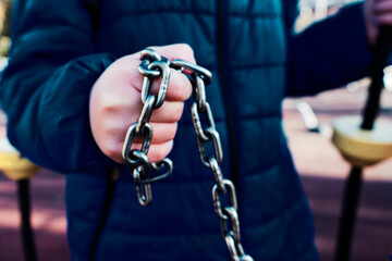 Hand with CHAIN,chain in hand,the chain wound on the hand,dirty hands,black background.