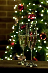 Two glasses of champagne on the background of a Christmas tree. New Year