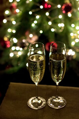 New Year's Eve and Christmas celebrations. Champagne on the background of a Christmas tree