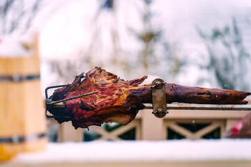 Pork leg on a spit with parts cut off