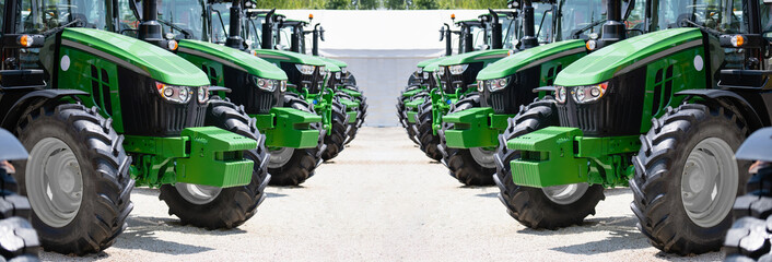 A row of green agricultural tractors - obrazy, fototapety, plakaty