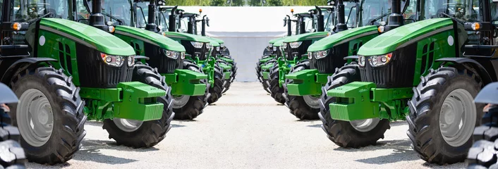 Fotobehang A row of green agricultural tractors © scharfsinn86