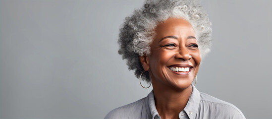 Portrait of very beautiful aged black woman with grey hair sliming to camera. - obrazy, fototapety, plakaty