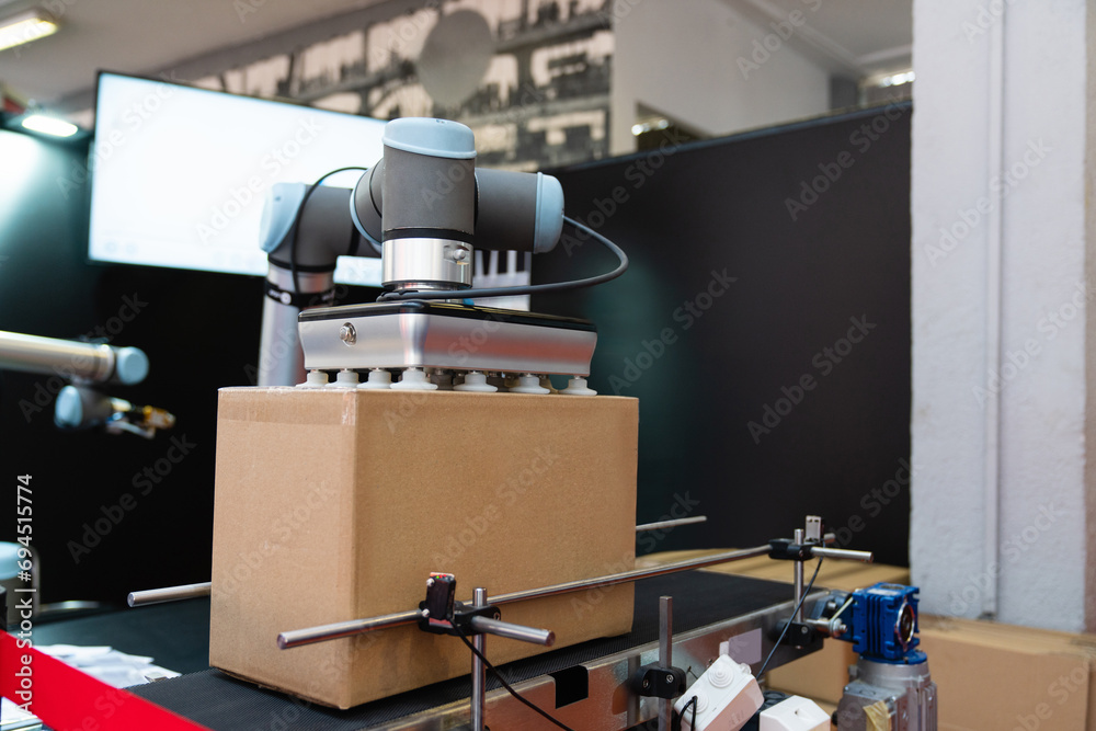 Poster robot arm moves box in an automatic warehouse