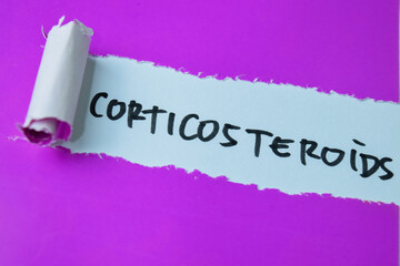 Concept Corticosteroids text written in torn paper. Medical concept