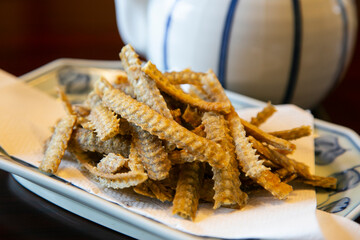 Fried eel bone. Crispy starter at a luxury Japanese restaurant in Tokyo