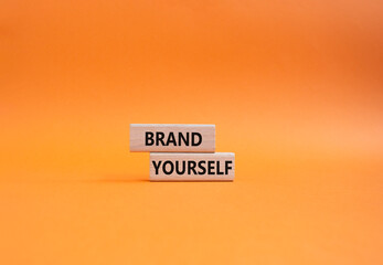 Brand yourself symbol. Concept word Brand yourself on wooden blocks. Beautiful orange background. Business and Brand yourself concept. Copy space