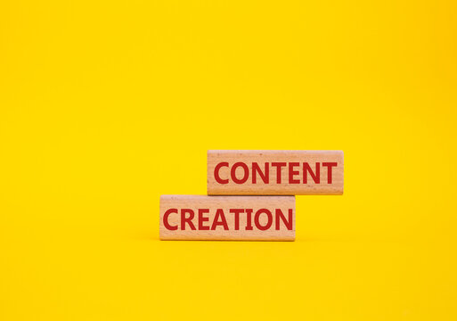 Content creation symbol. Concept word Content creation on wooden blocks. Businessman hand. Beautiful yellow background. Business and Content creation concept. Copy space