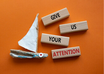 Attention symbol. Concept word Give us your attention on wooden blocks. Beautiful orange background with boat. Business and Give us your attention concept. Copy space © Natallia