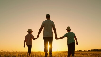 Kids dad travels to sunset, happy family. Silhouette. Father, sons walk together holding hands,...