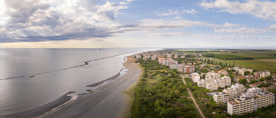 Drone view of sandy beach with umbrellas and gazebos.Summer vacation concept.Lido Adriano...