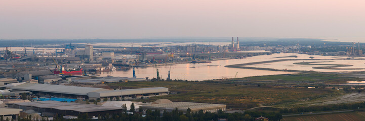 Aerial shot of industrial and port area of Ravenna,production district is made up of a chemical and...