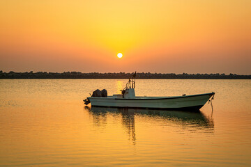 Naklejka premium Golden Hour Majesty: Sunrise Silhouettes of Boats on Dammam Corniche, Saudi Arabia
