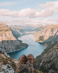 Norwegian mountain scene featuring visible shoes, evoking adventure and wanderlust