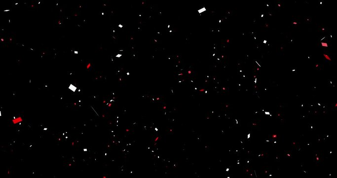 Red and white confetti (sprayed from the center) black background cracker celebration